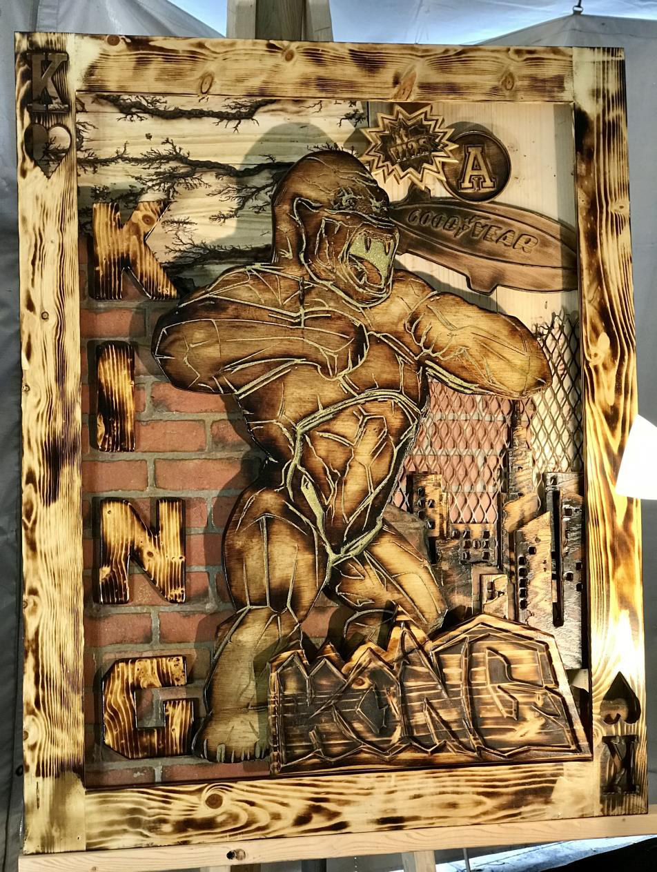 King Kong — Aged mahogany, imported Spanish cedar & royal oak with iron fencing and steel. Electric battery-burned wood., 48 × 56 in